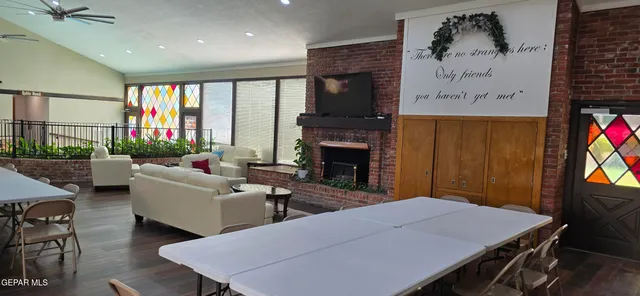 a living room with furniture a flat screen tv and a fireplace