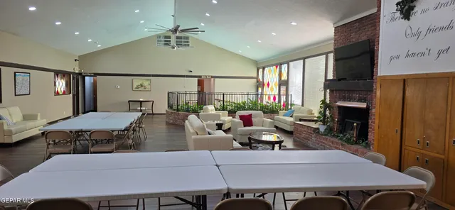 a living room with furniture kitchen view and a large window