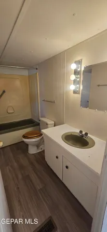 a bathroom with a sink a toilet and mirror