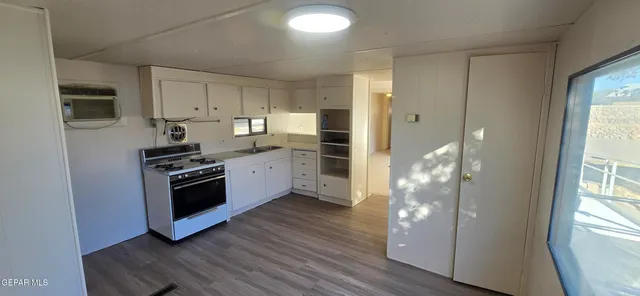 a kitchen with stainless steel appliances a refrigerator and a stove top oven