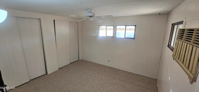 a front view of a house with a tree