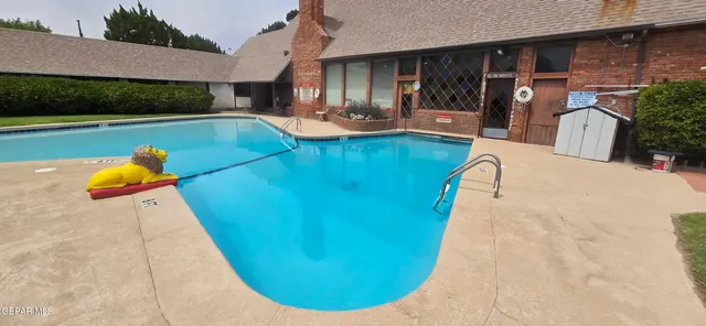 a view of a swimming pool with lounge chair