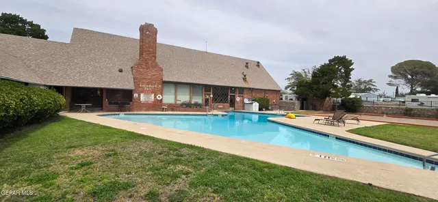 a view of a house with swimming pool yard and outdoor seating