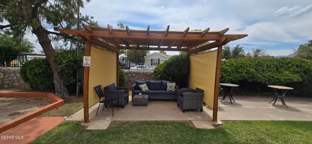 a view of a patio with couches table and chairs and potted plants