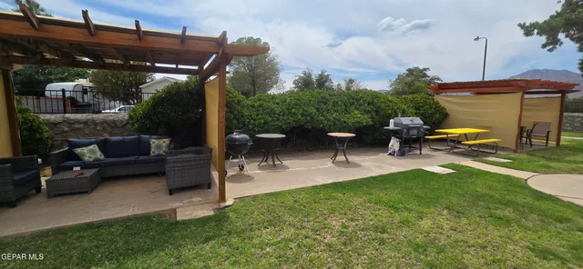 a view of a patio with a table and chairs