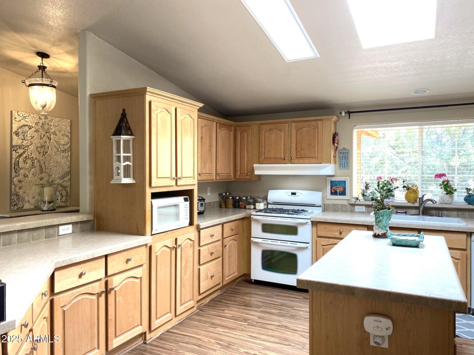 181 Timber Ridge Loop Show Low, AZ 85901 - Photo 18 of 57 a kitchen with stainless steel appliances granite countertop a stove a sink and a refrigerator