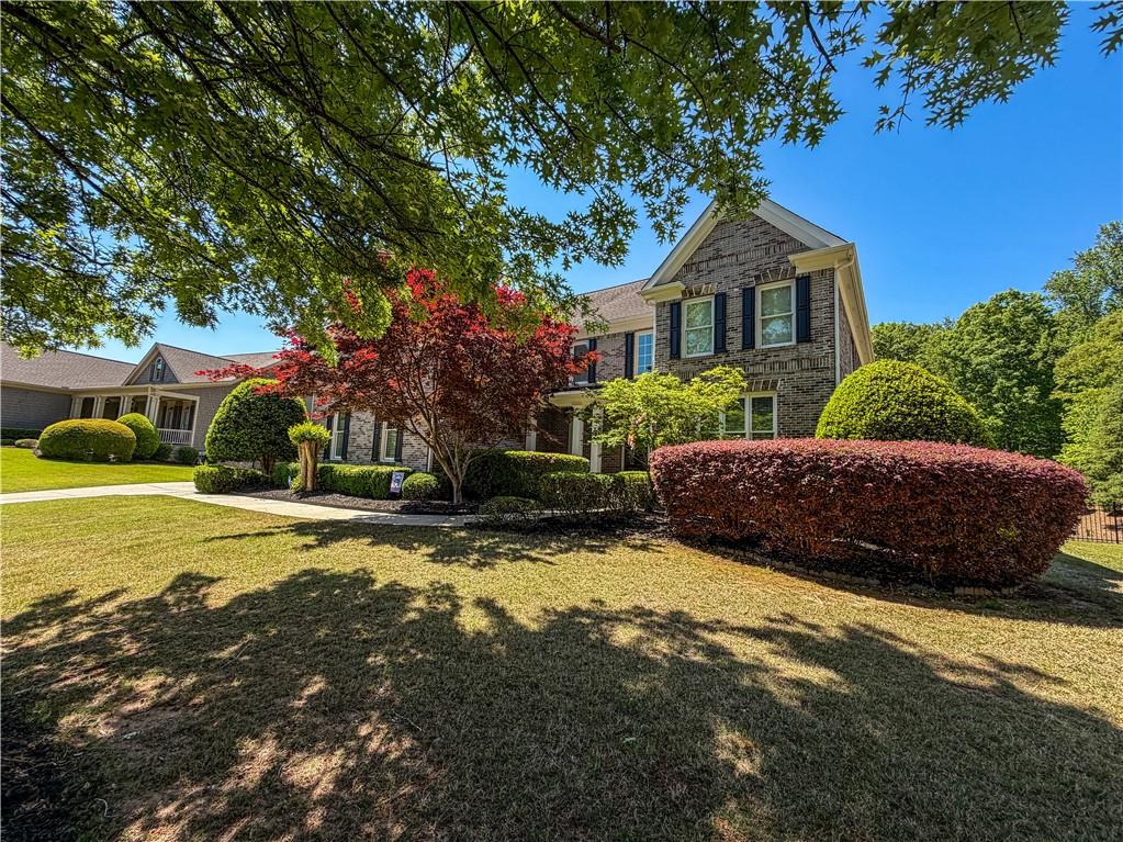 310 Flatstone Way Marietta, GA 30064 - Photo 1 of 44 a front view of a house with a yard and garage