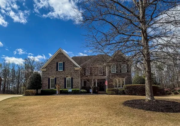 a front view of a house with a yard