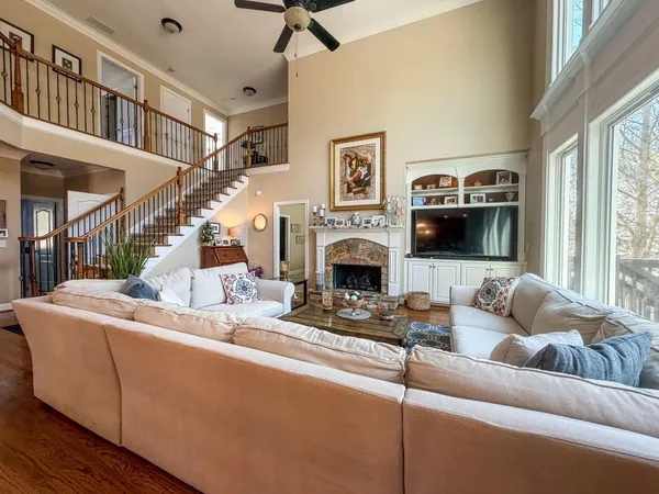 a living room with furniture a flat screen tv and a fireplace