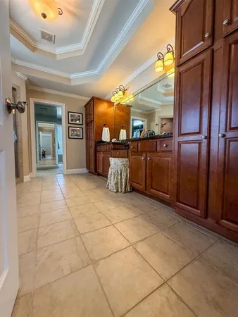 a view of a refrigerator in kitchen and an empty room