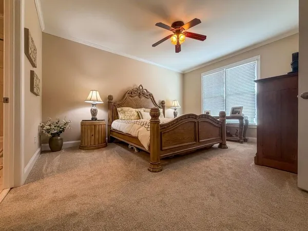 a spacious bedroom with a bed and a chandelier