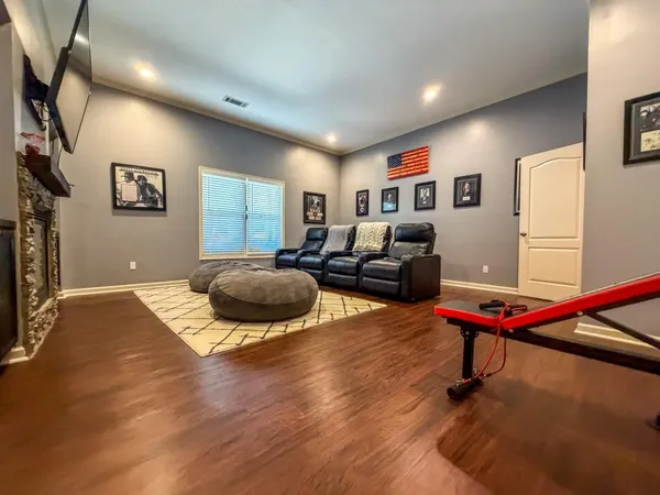 a living room with furniture pool table and a flat screen tv