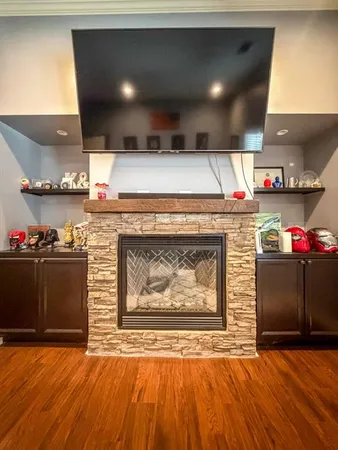 a open kitchen with a fireplace and a counter space