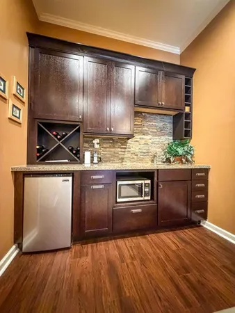 a kitchen with granite countertop wooden cabinets and stainless steel appliances