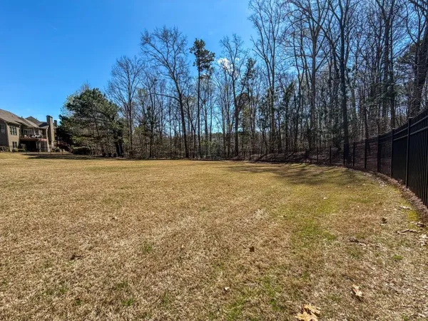 a view of a yard with a house in the background