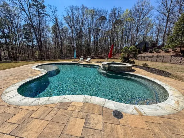 a view of a swimming pool with a yard