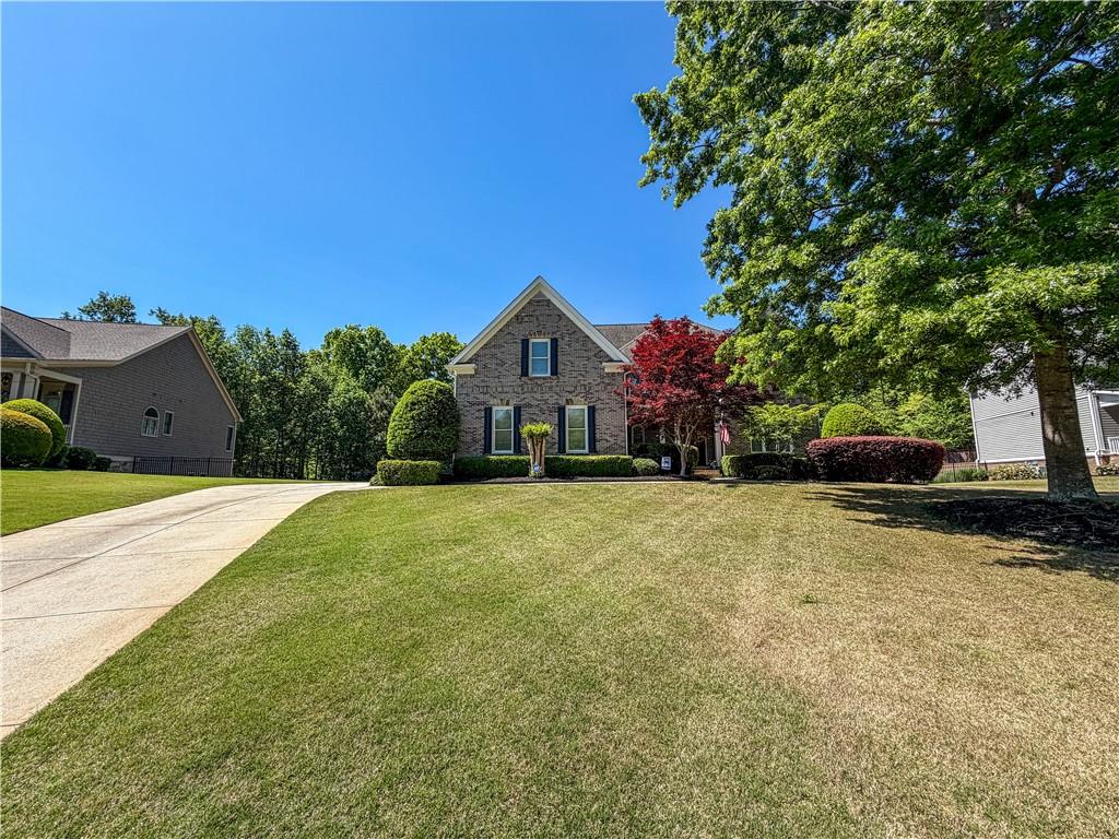 310 Flatstone Way Marietta, GA 30064 - Photo 6 of 44 a front view of a house with a yard and trees