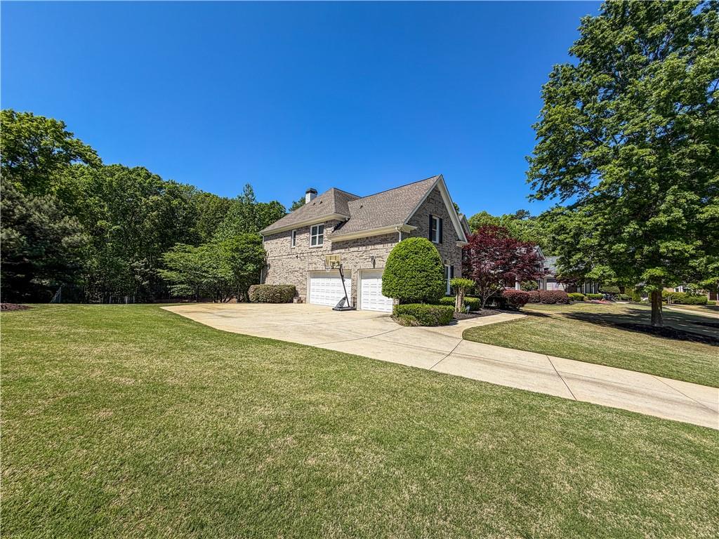 310 Flatstone Way Marietta, GA 30064 - Photo 7 of 44 a view of a house with a yard and a garage