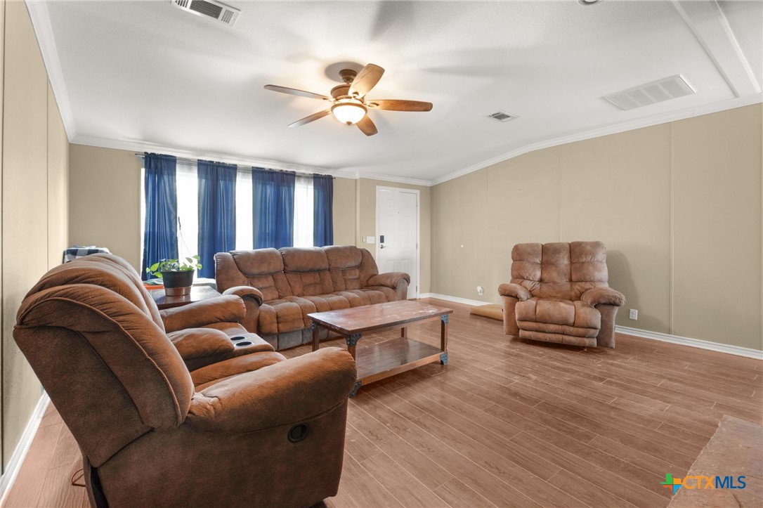 411 Private Road 3447 Kempner, TX 76539 - Photo 11 of 33 a living room with furniture and a chandelier