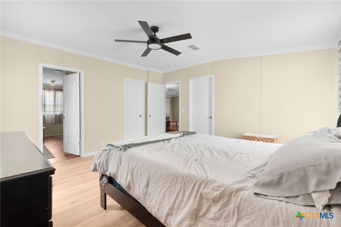 411 Private Road 3447 Kempner, TX 76539 - Photo 12 of 33 a bedroom with a bed and a chandelier