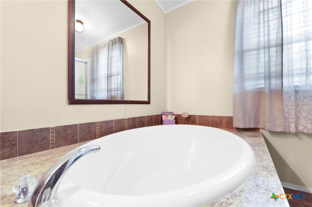 411 Private Road 3447 Kempner, TX 76539 - Photo 15 of 33 a white bath tub sitting in a bathroom