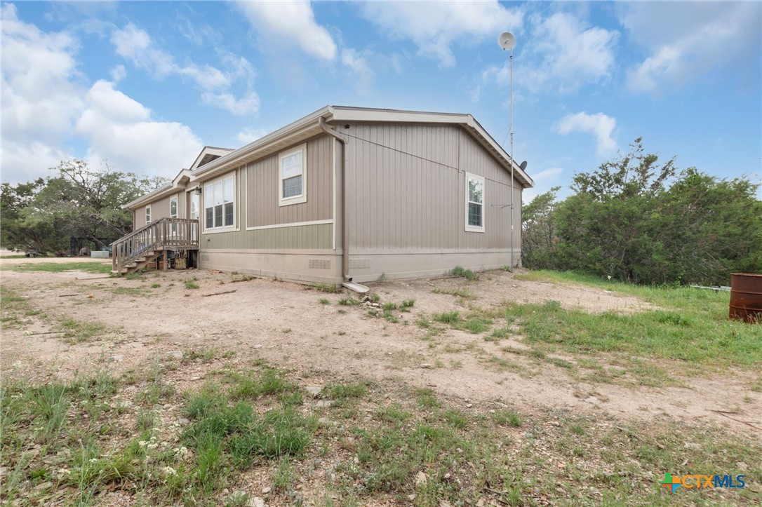 411 Private Road 3447 Kempner, TX 76539 - Photo 26 of 33 a house with trees in the background