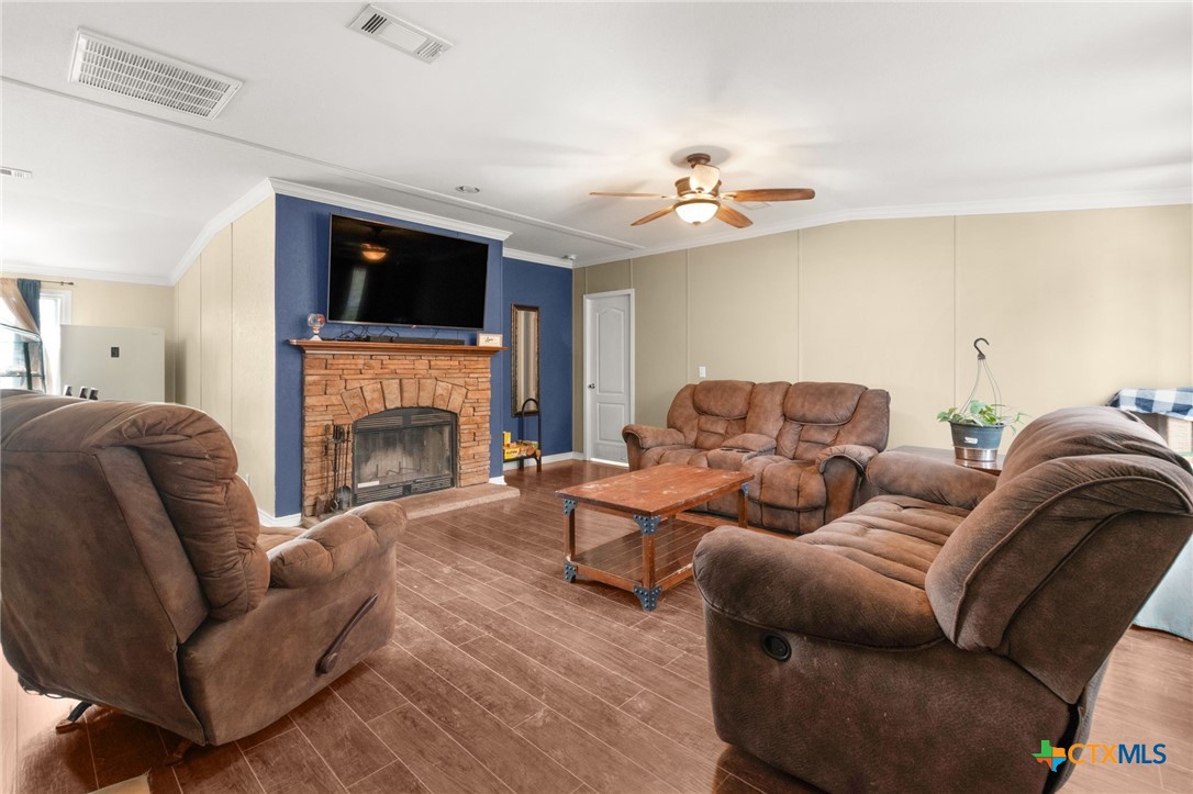 411 Private Road 3447 Kempner, TX 76539 - Photo 3 of 33 a living room with furniture a flat screen tv and a fireplace