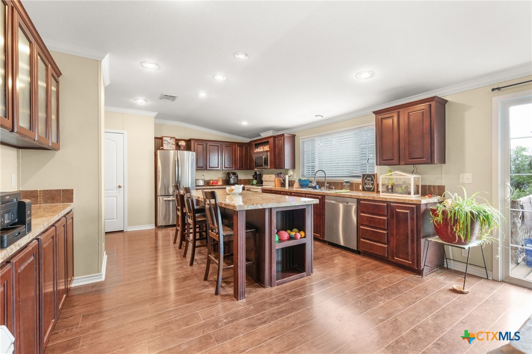 411 Private Road 3447 Kempner, TX 76539 - Photo 6 of 33 a kitchen with a sink a counter top space and stainless steel appliances