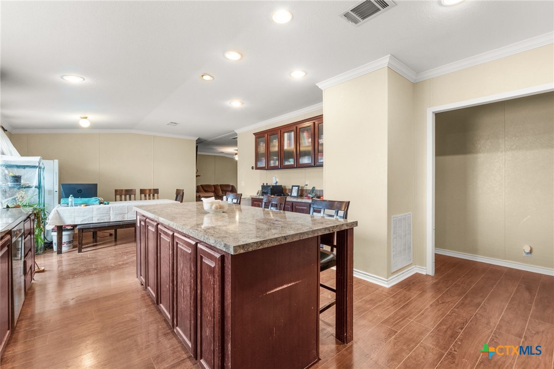 411 Private Road 3447 Kempner, TX 76539 - Photo 9 of 33 a kitchen with a sink cabinets and wooden floor
