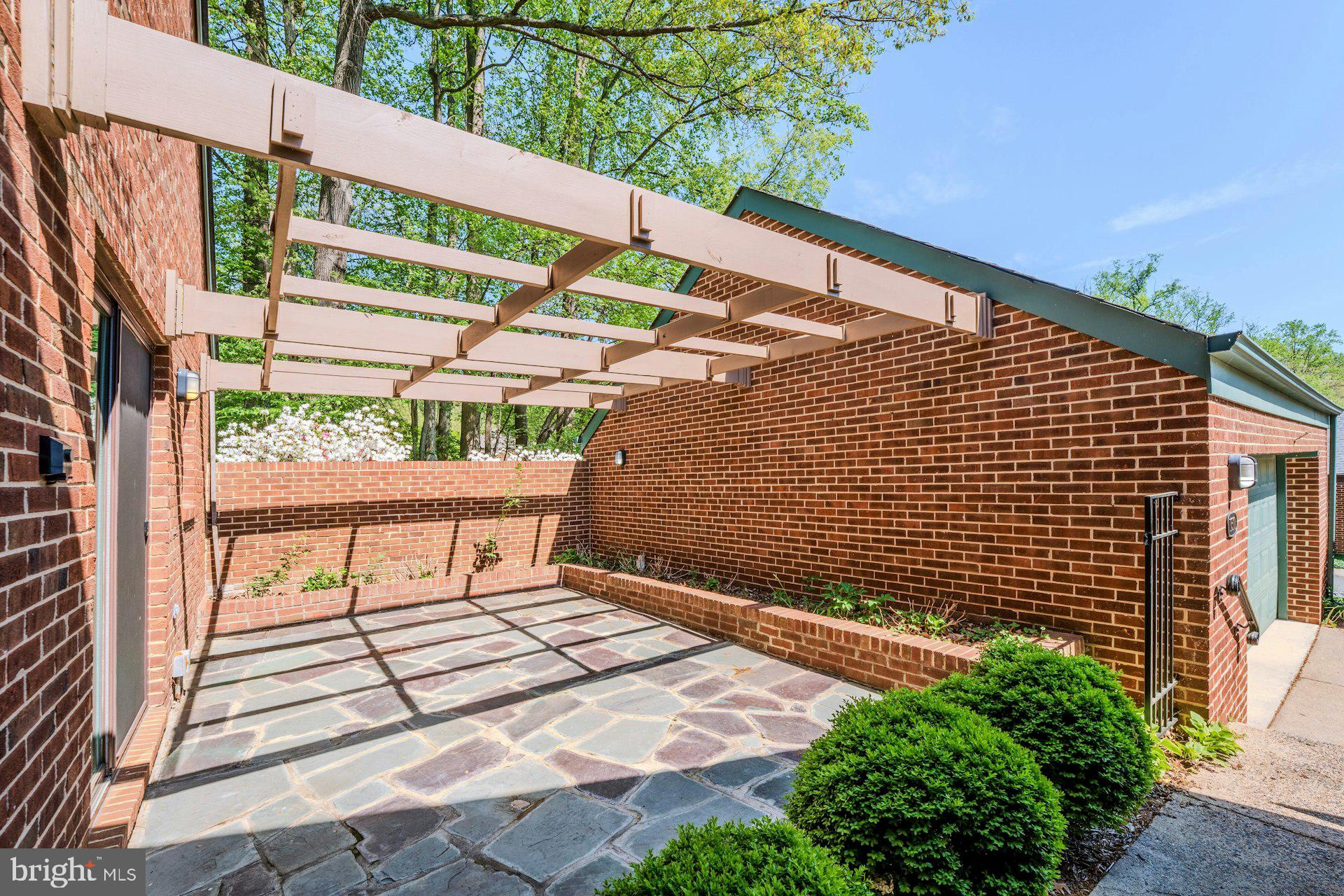 11310 Harborside Cluster Reston, VA 20191 - Photo 8 of 71 Quaint patio between detached garage and home.