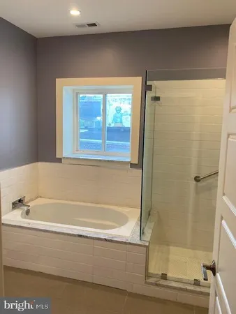 a bathroom with a bathtub and a shower