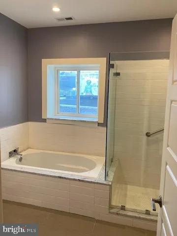a bathroom with a bathtub and a shower