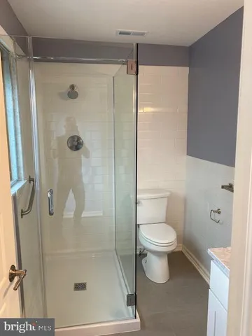 a bathroom with a toilet and a shower