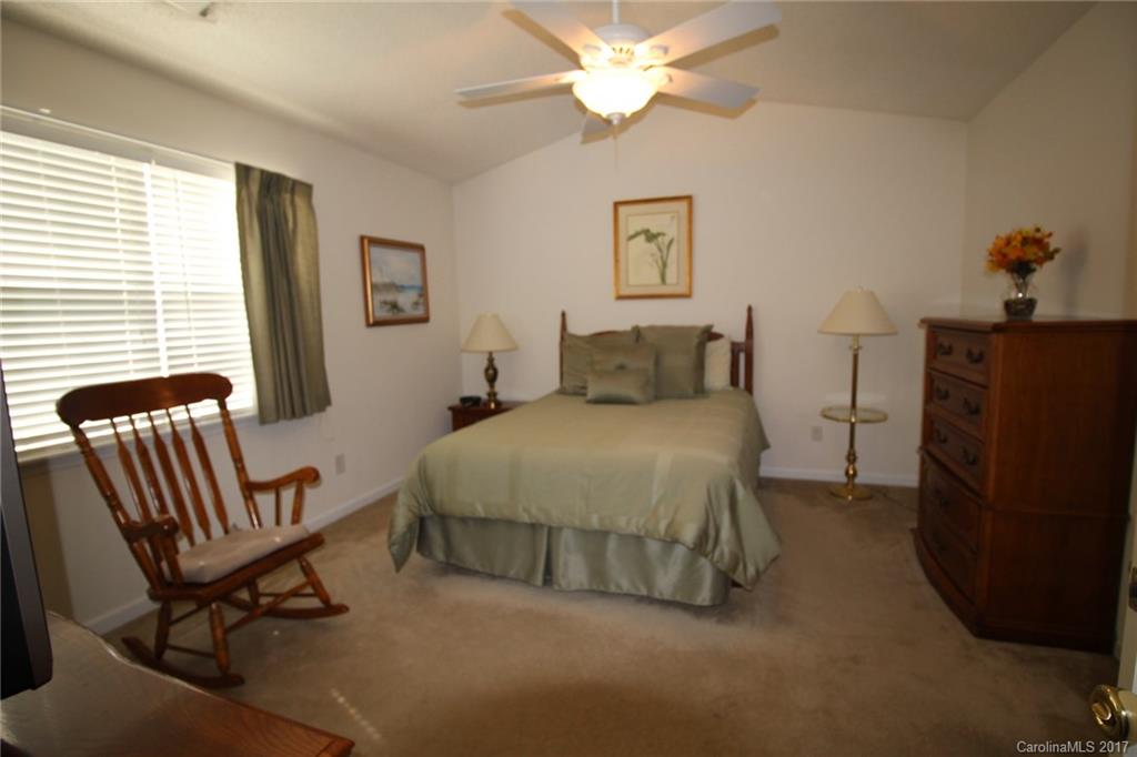 8272 Rudolph Road, Unit 8272 Charlotte, NC 28216 - Photo 11 of 17 a bedroom with a bed and a chair