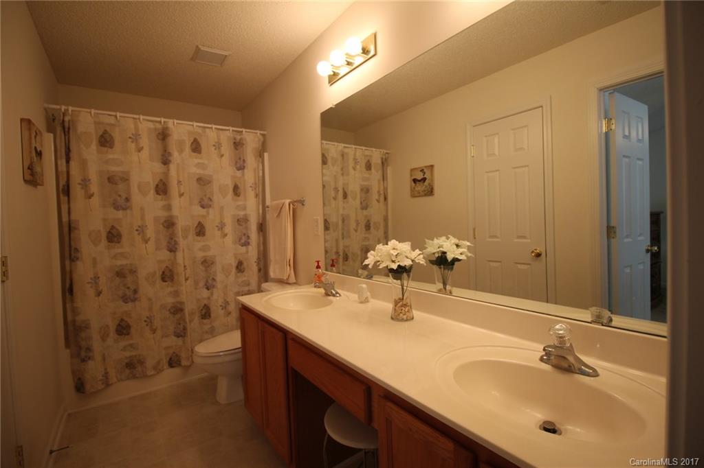 8272 Rudolph Road, Unit 8272 Charlotte, NC 28216 - Photo 12 of 17 a bathroom with a double vanity sink mirror and shower