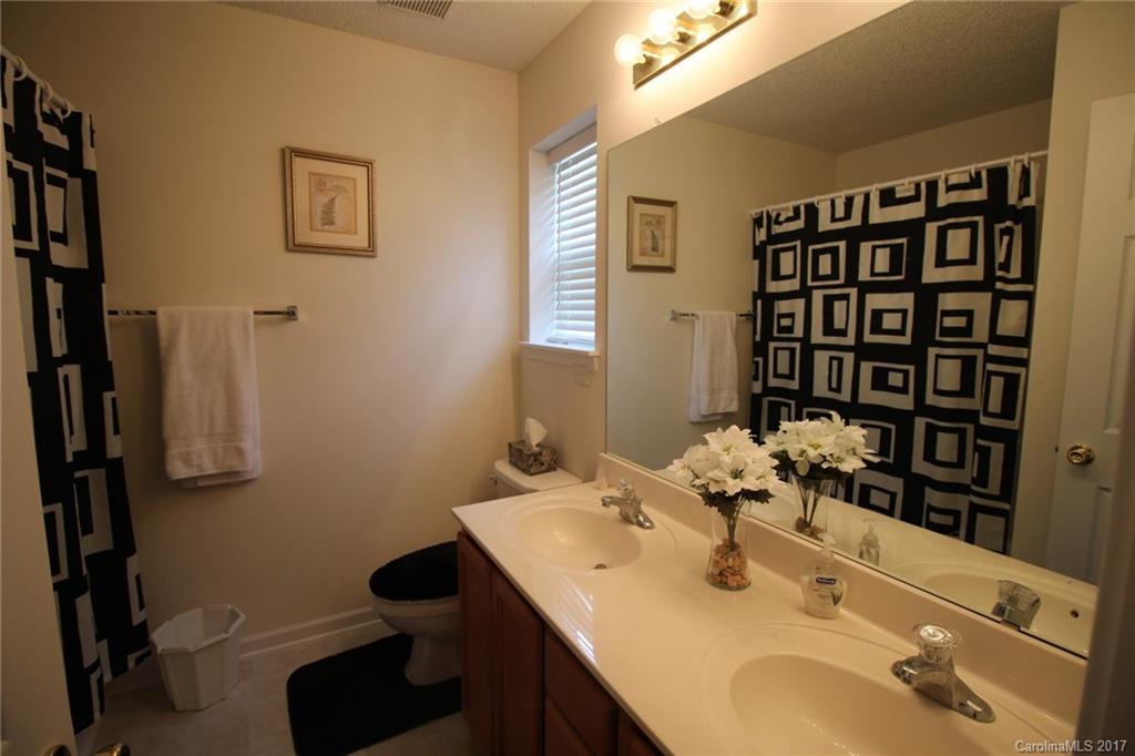 8272 Rudolph Road, Unit 8272 Charlotte, NC 28216 - Photo 14 of 17 a bathroom with a sink and a mirror