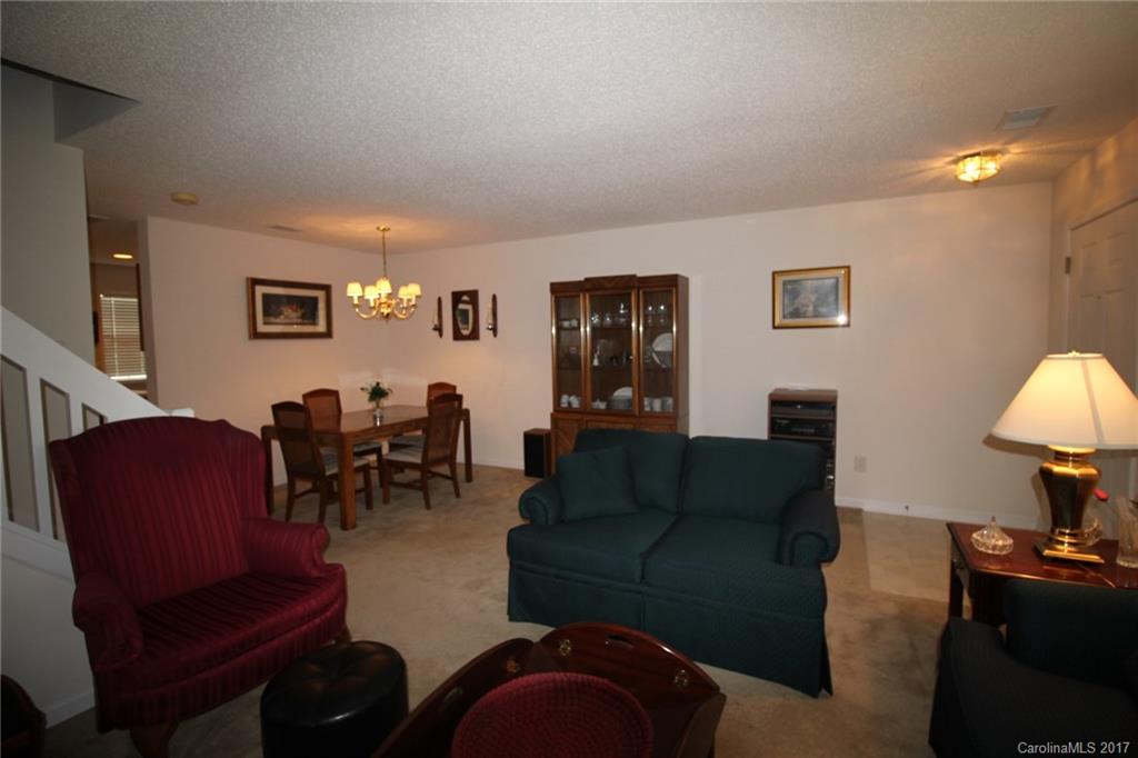 8272 Rudolph Road, Unit 8272 Charlotte, NC 28216 - Photo 4 of 17 a living room with furniture and a lamp