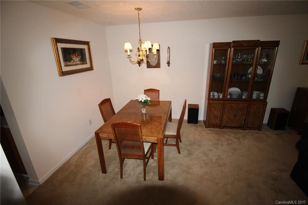 8272 Rudolph Road, Unit 8272 Charlotte, NC 28216 - Photo 5 of 17 a view of a dining room with furniture and window