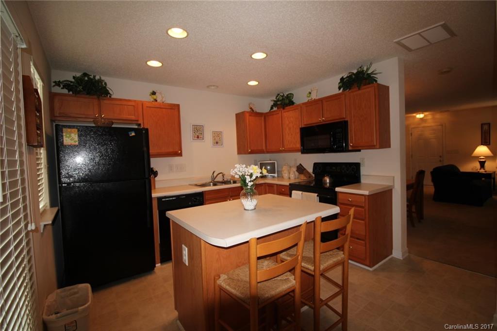 8272 Rudolph Road, Unit 8272 Charlotte, NC 28216 - Photo 8 of 17 a kitchen with a sink a refrigerator and a stove