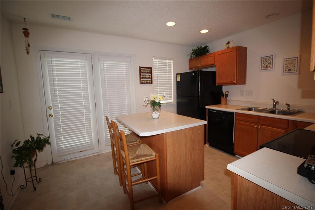 8272 Rudolph Road, Unit 8272 Charlotte, NC 28216 - Photo 9 of 17 a kitchen that has a sink and a stove in it