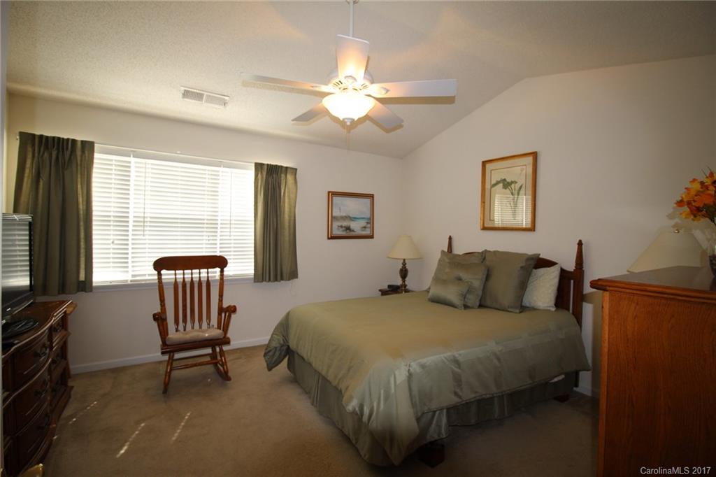 8272 Rudolph Road, Unit 8272 Charlotte, NC 28216 - Photo 10 of 17 a bedroom with a bed chairs and a window
