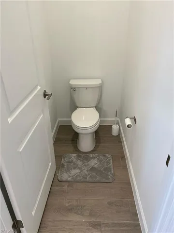 a bathroom with a toilet and a rug
