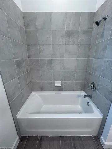 a white bath tub and shower