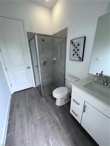 a spacious bathroom with a granite countertop sink toilet and shower