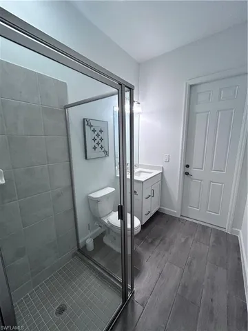 a spacious bathroom with a toilet and a shower