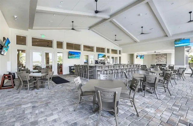 a outdoor space with lots of tables a garden view and chairs