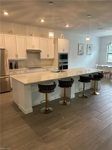 a living room with stainless steel appliances kitchen island granite countertop furniture and a kitchen view