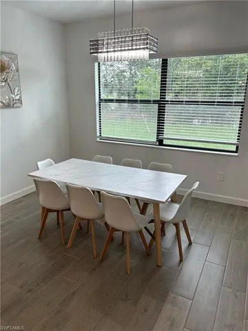 a dining room with furniture and window
