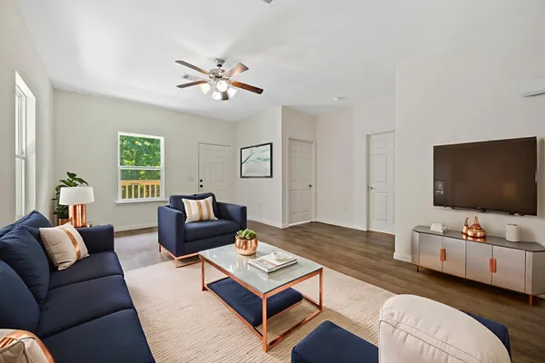 a living room with furniture and a flat screen tv