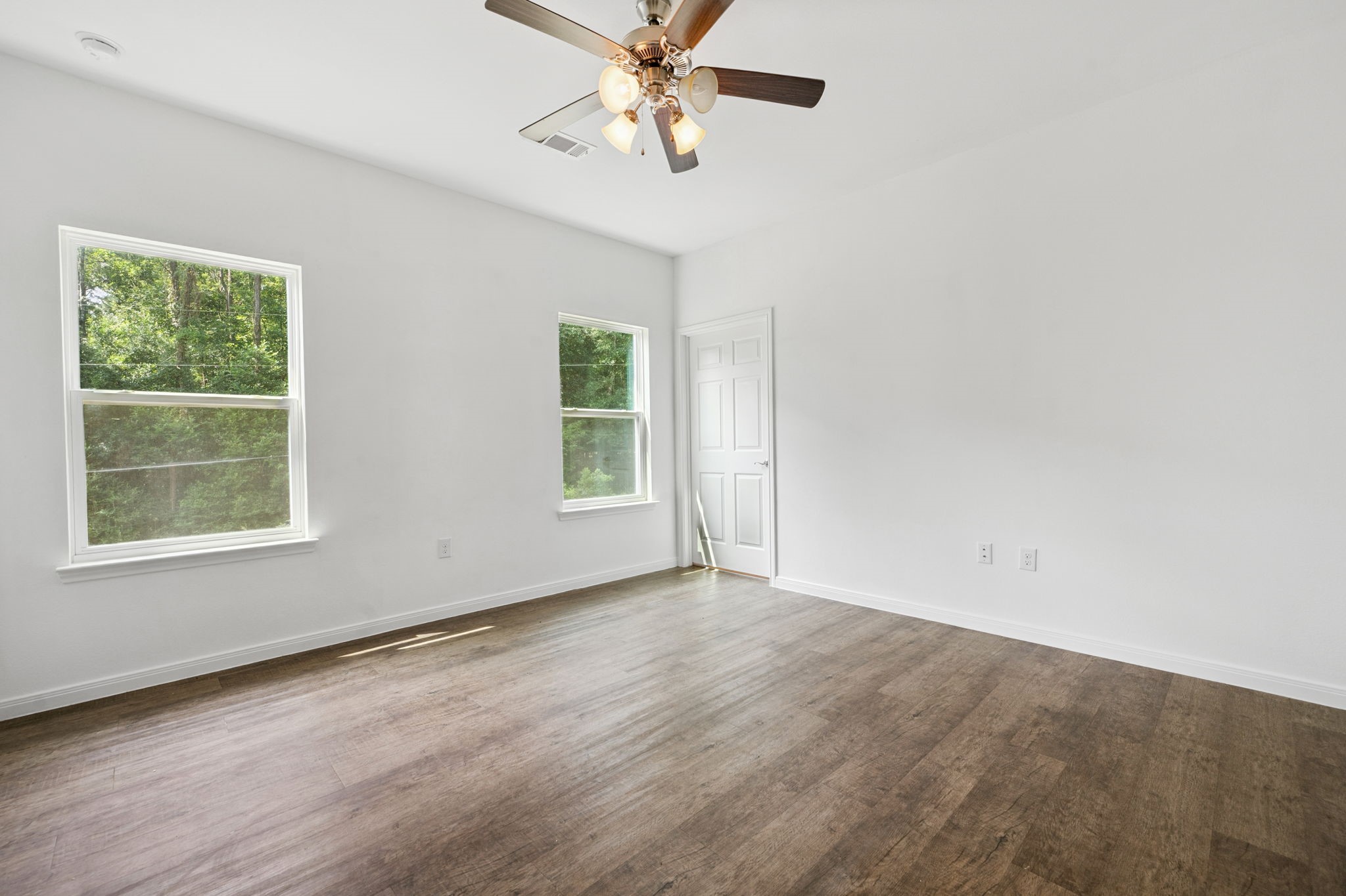 325 Cemetery Road Coldspring, TX 77331 - Photo 13 of 31 an empty room with windows and fan
